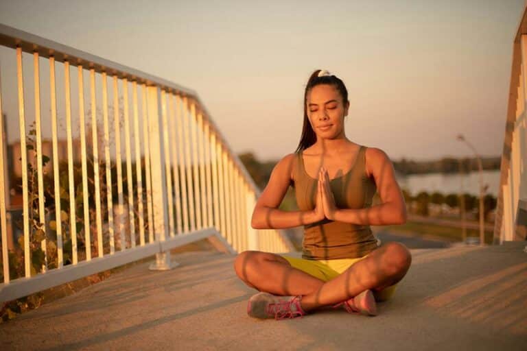 african woman working yoga on the bridge