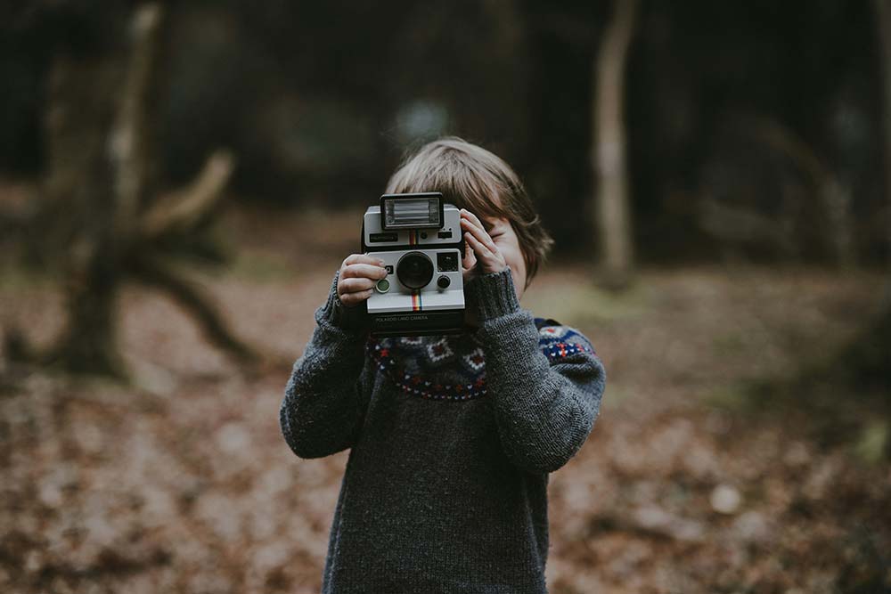 Kid holding a camera.
